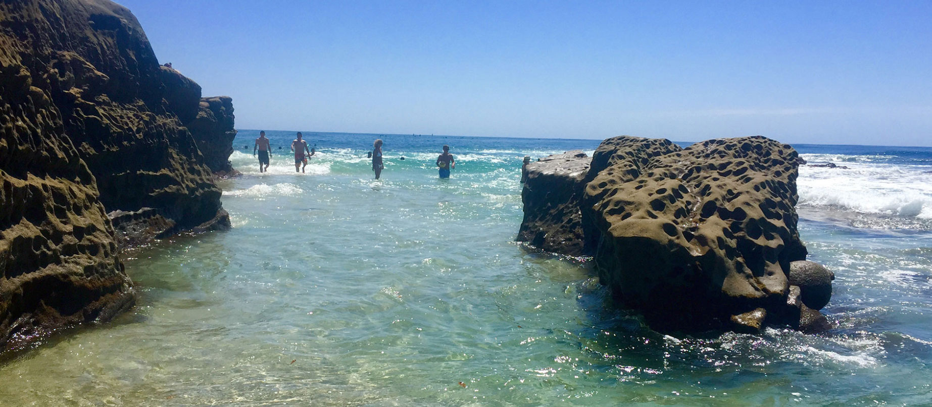 Ocean scenery with people standing in water