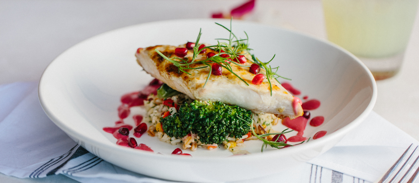 Plated fish on a bed of rice